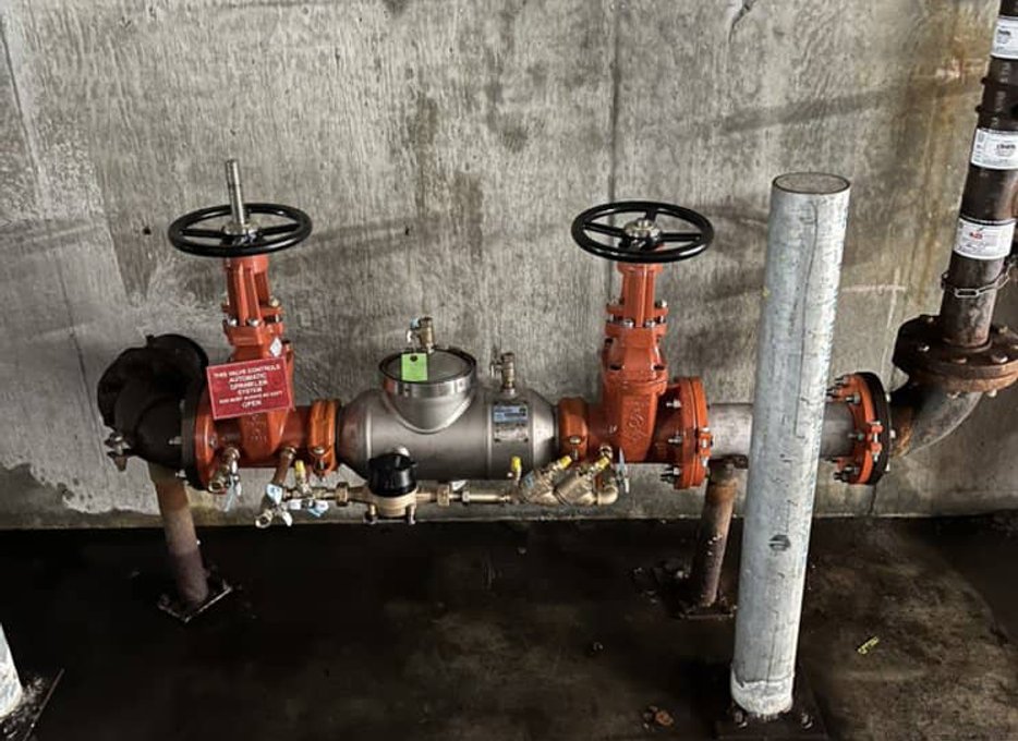 Old backflow unit with exposed piping